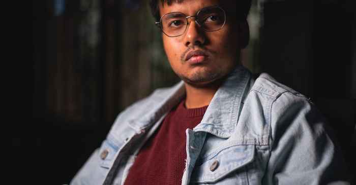 young japanese man looking forward sunrise determination