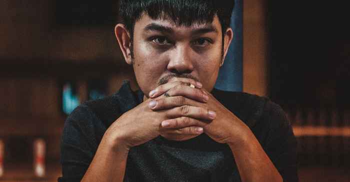 japanese man thoughtful serious question thinking city