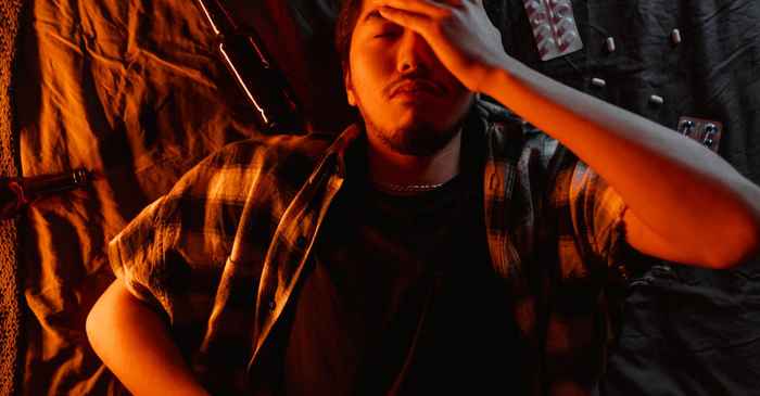 japanese man frustrated phone alone room dark