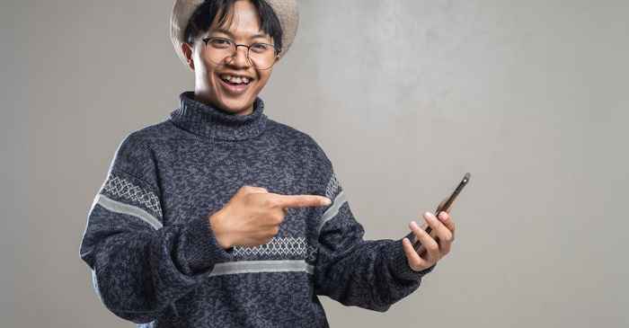 japanese man smartphone app smiling confident better choice