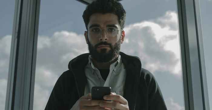 japanese man thoughtful question looking serious smartphone