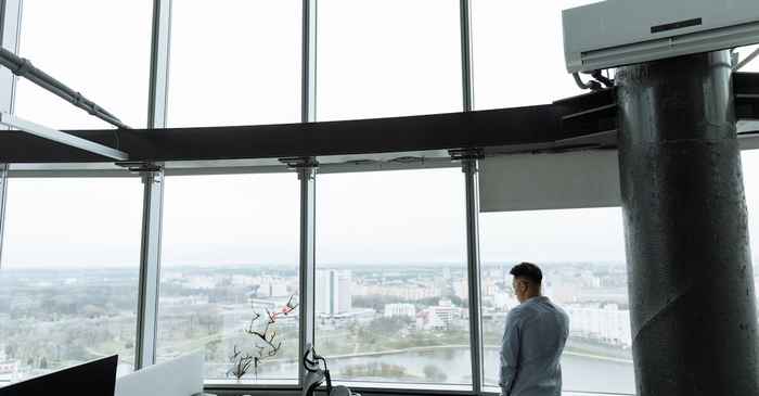 japanese middle aged man alone thinking office window