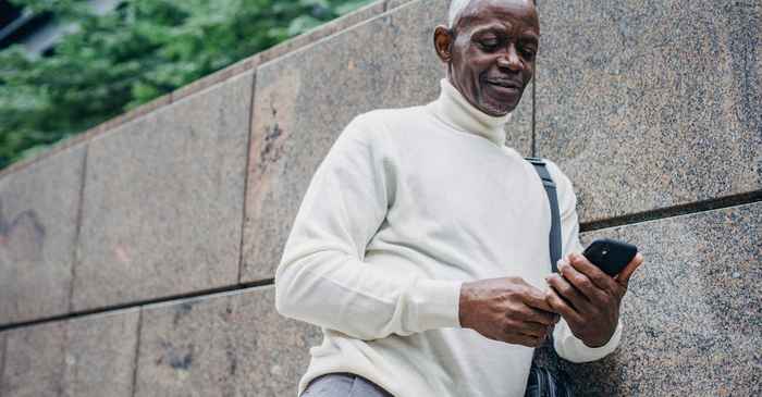 japanese mature man smartphone smiling hope new start